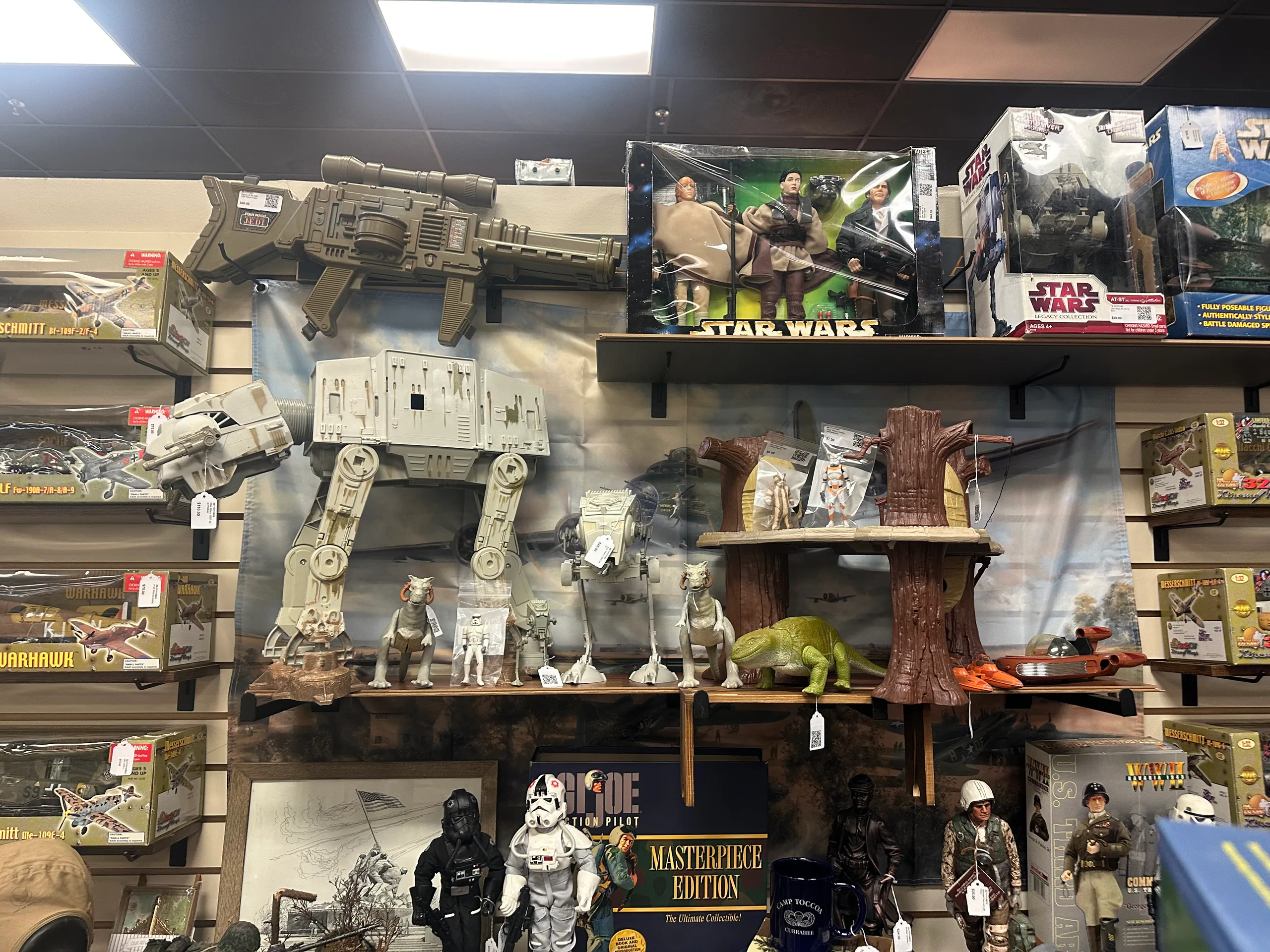 A wall of Star Wars vehicles, figures, and boxed collectibles inside The Wilcox Vault booth