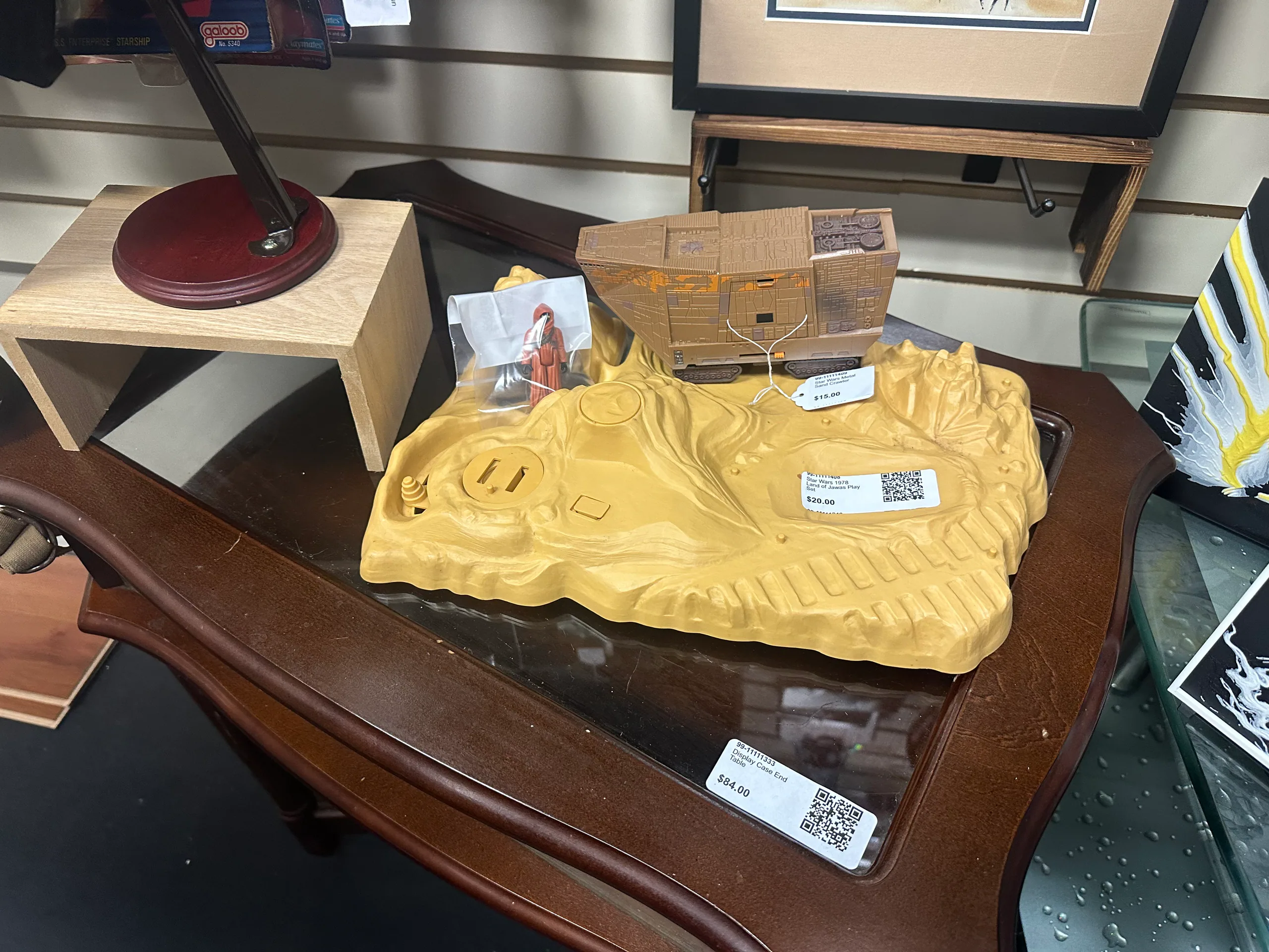 Vintage Star Wars land vehicle and playset displayed on a wooden table