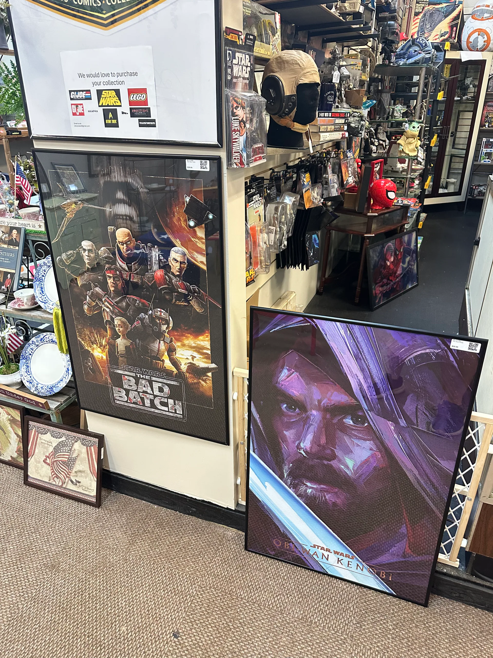 Framed Star Wars artwork and collectibles lining the booth aisle